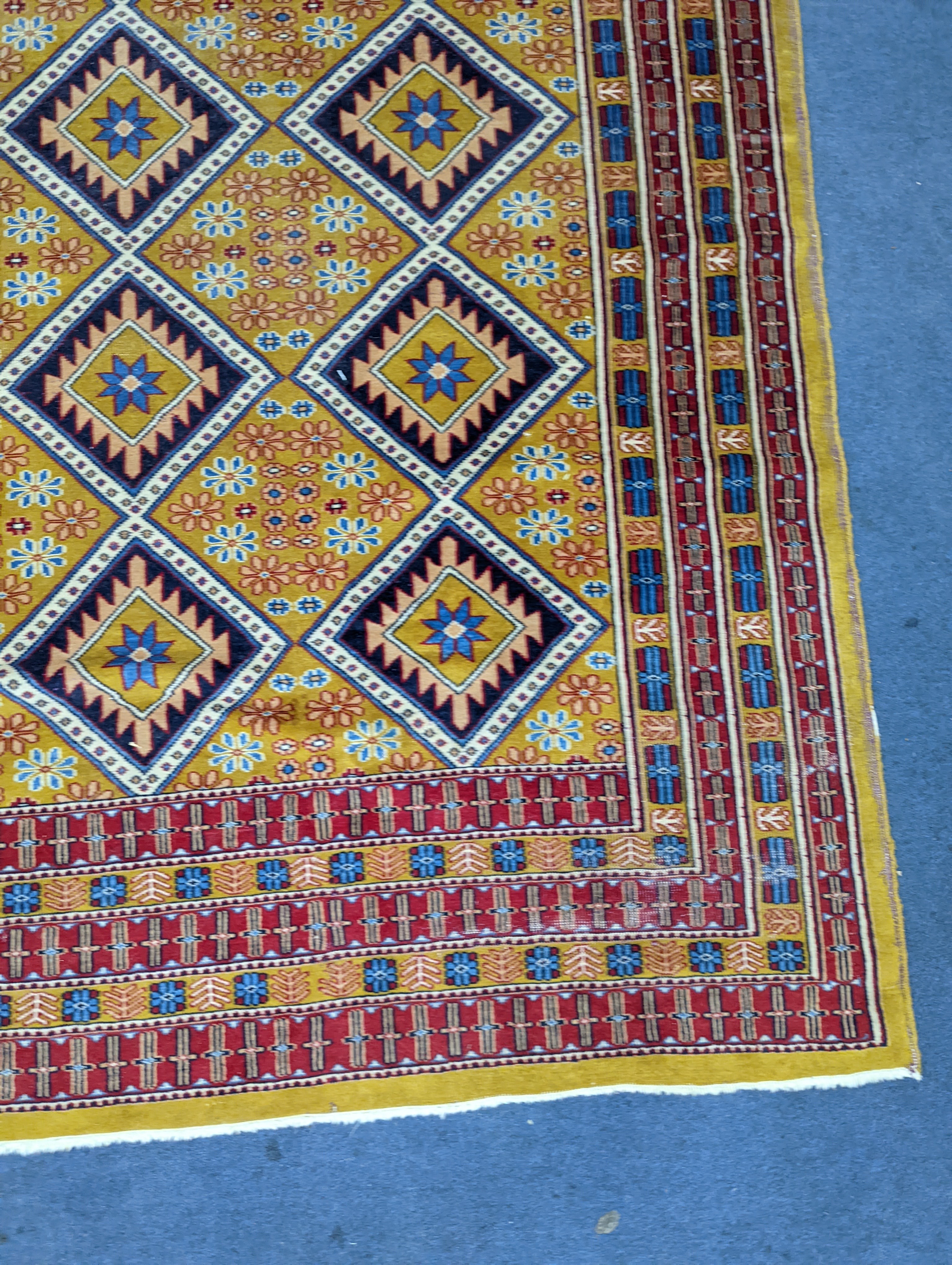 A Caucasian style gold ground rug, 190 x 124cm